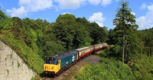 A heritage diesel train travelling on the Bodmin & Wenford Railway