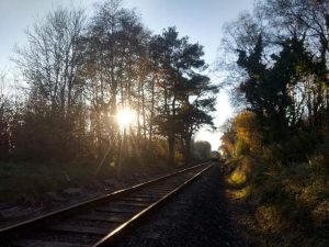 The sun over the train tracks on the Bodmin & Wenford Railway