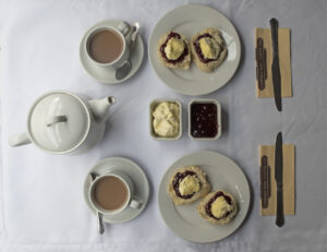 Cream tea set out on a vintage carriage table